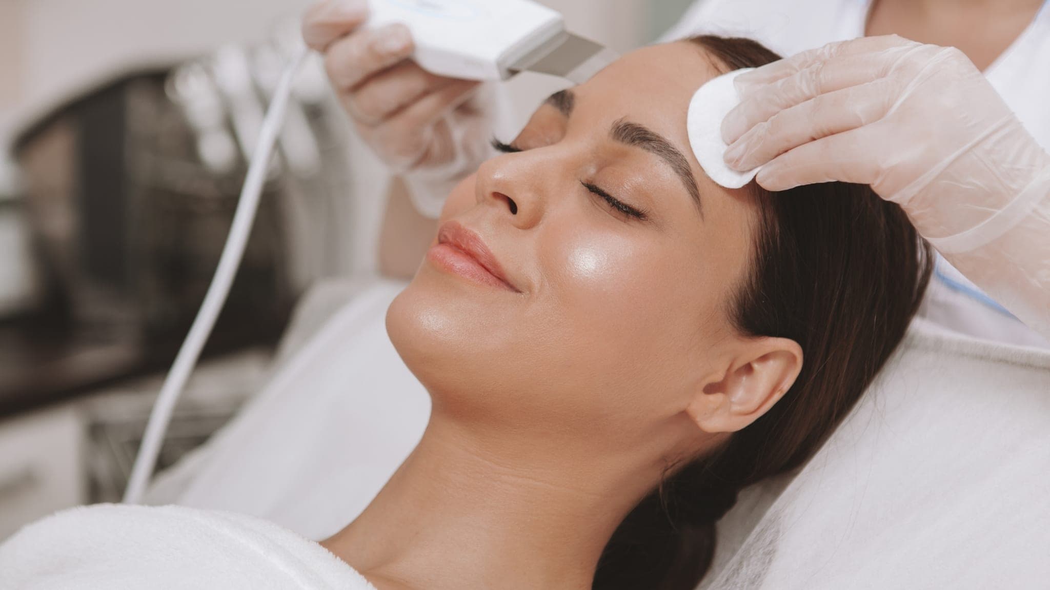 Tratamiento facial ultrasónico en un ambiente de med spa limpio y relajado